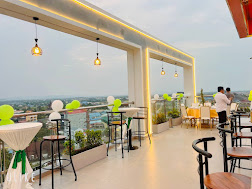 Open-air skybar at sunset with river views — sister hotel next door
